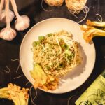 Homemade Asian Garlic Noodles tossed in a savory garlic sauce, displayed in a skillet and bowl for a delicious restaurant-style meal.