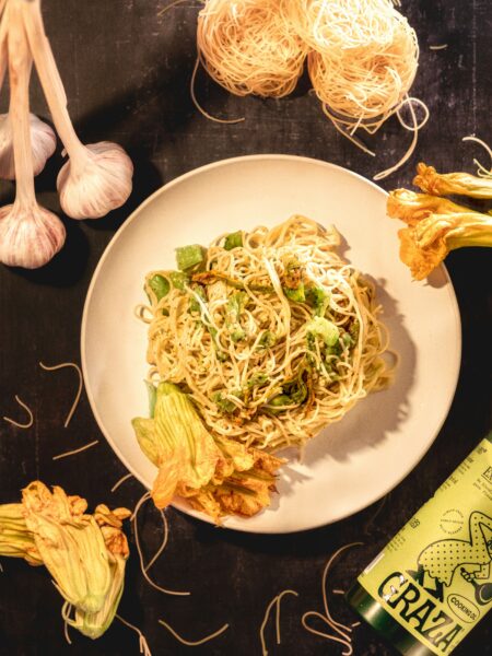 Homemade Asian Garlic Noodles tossed in a savory garlic sauce, displayed in a skillet and bowl for a delicious restaurant-style meal.