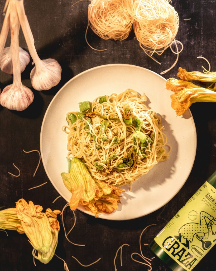 Homemade Asian Garlic Noodles tossed in a savory garlic sauce, displayed in a skillet and bowl for a delicious restaurant-style meal.