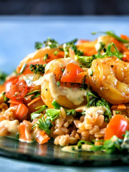 Asian shrimp stir fry with juicy shrimp, broccoli, bell peppers, snap peas, carrots, and onions cooked in a savory garlic soy sauce in a wok.